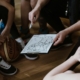 Close-up of a basketball team huddling with the coach discussing strategy indoors.