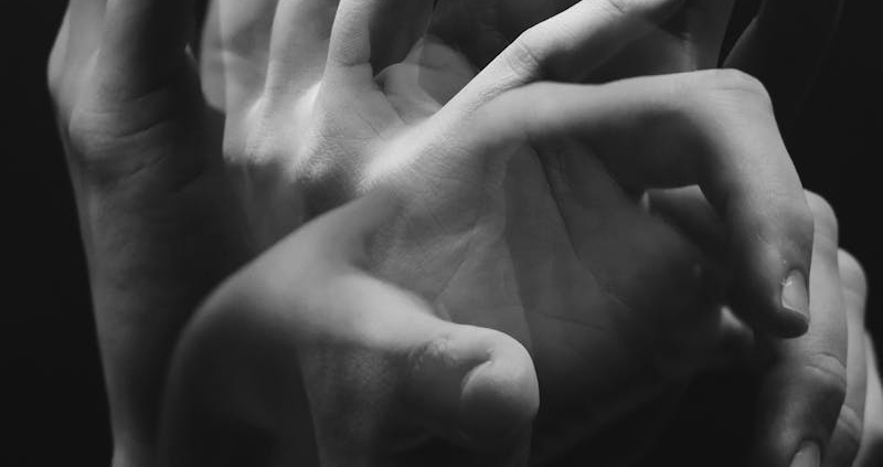 A monochromatic image capturing the fluid motion of hands in a conceptual style.