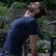 a man sitting on a yoga mat in the middle of a forest