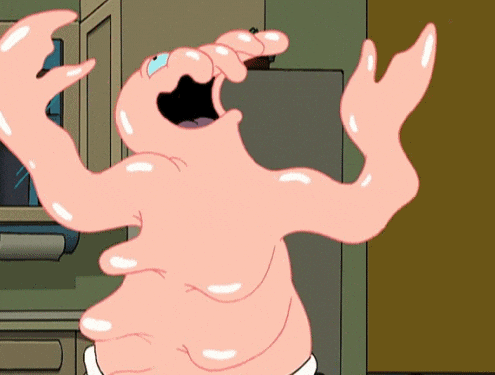 Pink gelatinous cartoon creature with outstretched arms and open mouth in a kitchen doorway, appearing surprised or scared.