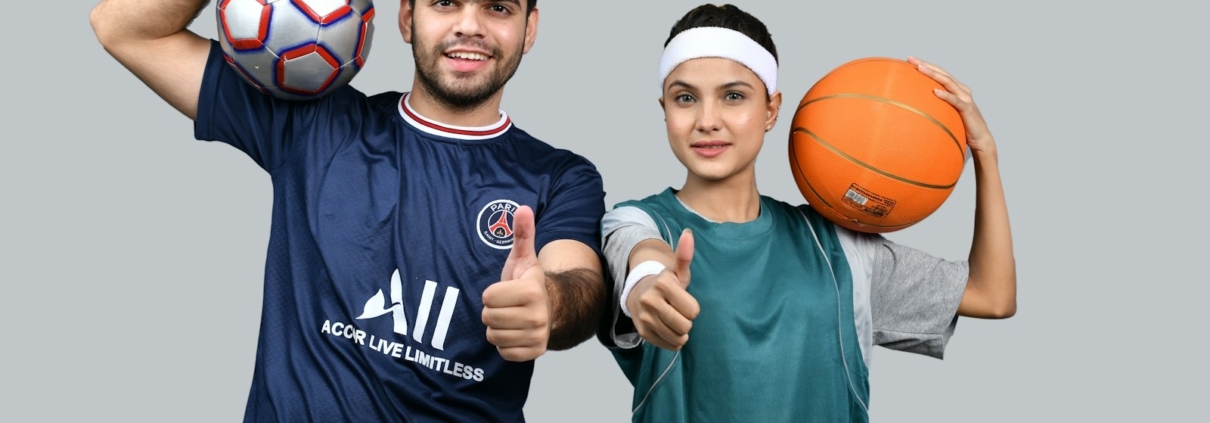 a man and a woman holding a basketball and posing for the camera