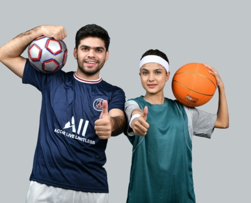 a man and a woman holding a basketball and posing for the camera