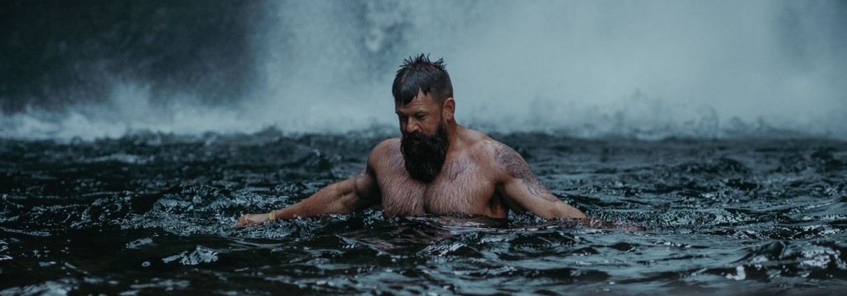 Adult male enjoying a relaxing swim in the Cascade Locks waterfall in Oregon, USA.