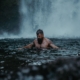 Adult male enjoying a relaxing swim in the Cascade Locks waterfall in Oregon, USA.